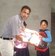 Rev .Suroya Giving Educational Material to Poor Child.