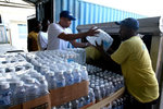 Food for the Poor delivering water in Haiti (source: http://www.foodforthepoor.org/help/quake_updates/relief_updates.html)