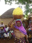 Ghanaian woman participating in shea butter making process