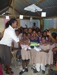 This Phyllis in the picture distributing books to children in one of the local schools