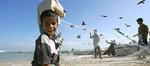 Fishermen collect small fish from fishing nets. A partnership between Allianz and CARE International provides microinsurance to thousands of poor fishermen in southern India, http://knowledge.allianz.com/search.cfm?83/microinsurance-allianz-care-tamil-nad