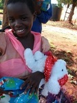 A child smiling after receiving a christmas gift