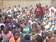 Am the one standing in a red  and a coat checking on themeals served to children 