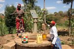 WOMEN AT HAND DUG WELL