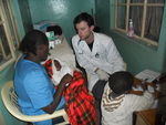 our Doctor is overseeing a medical student talking to a mother in the hospital