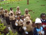 Children line up for break-time nutritious porridge